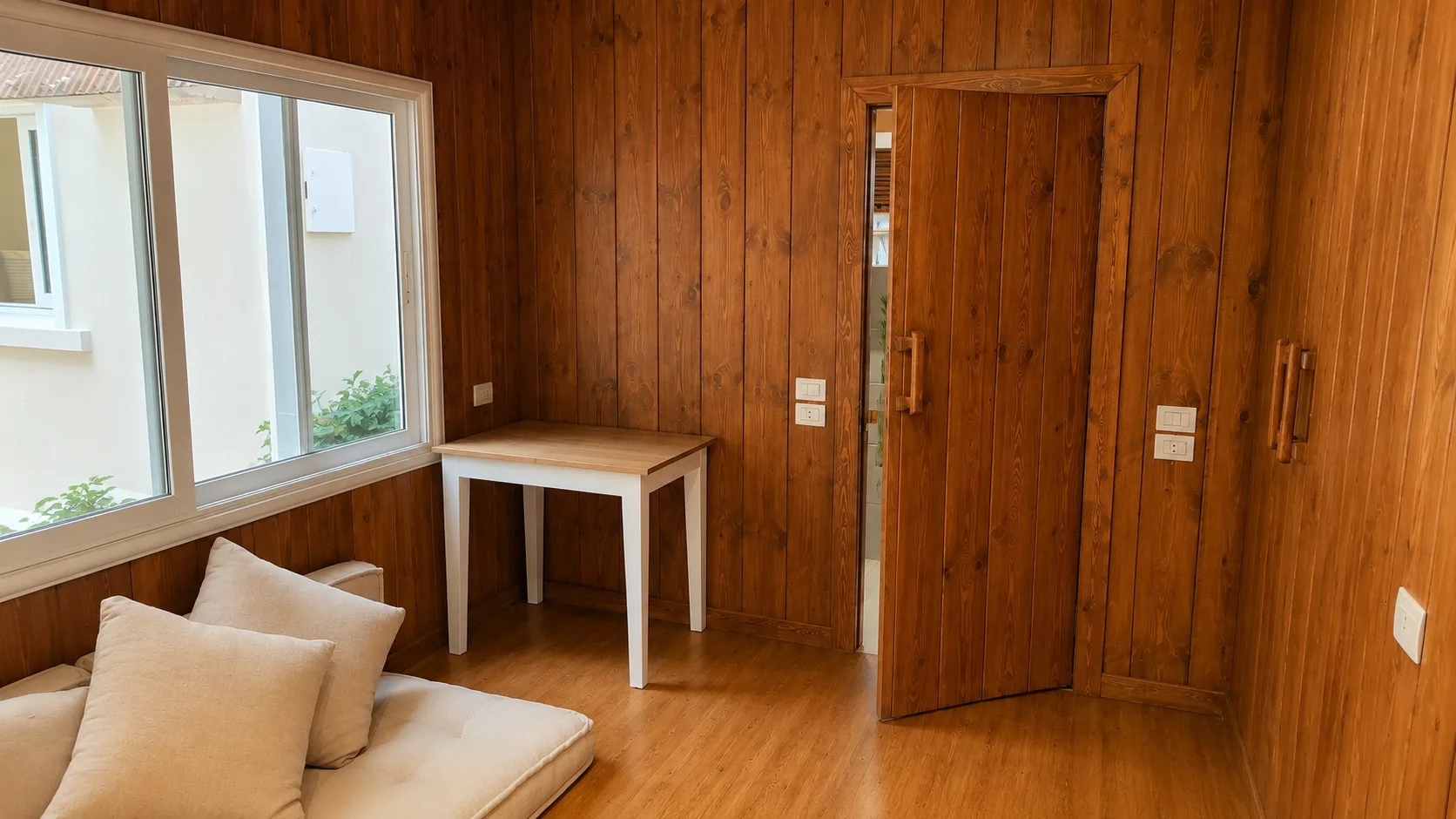 Wood-panelled bedroom and desk in the Maadi Villa project in Maadi