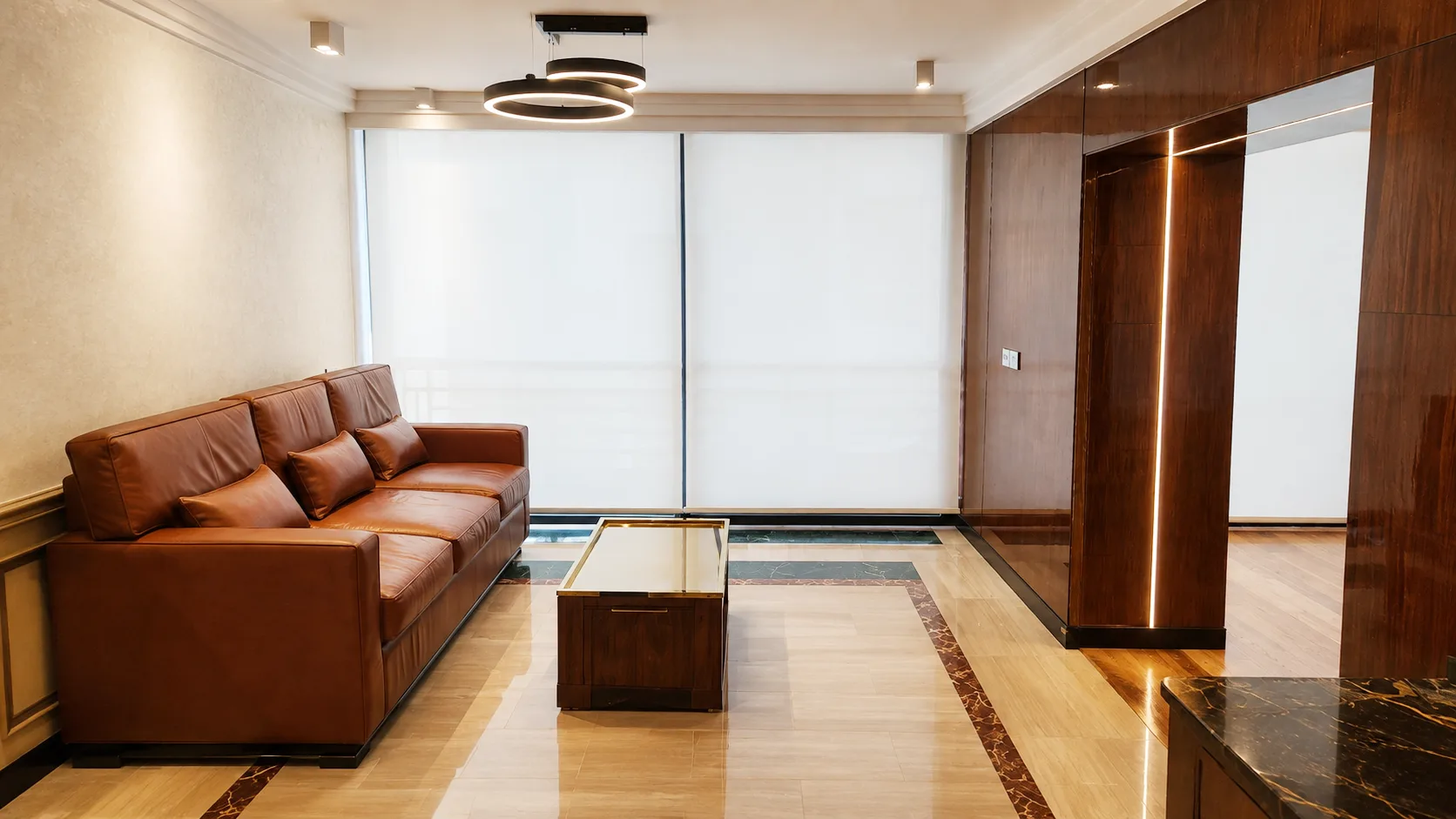 Simple living room with leather sofa in the Dakahlia Group project in Nasr City