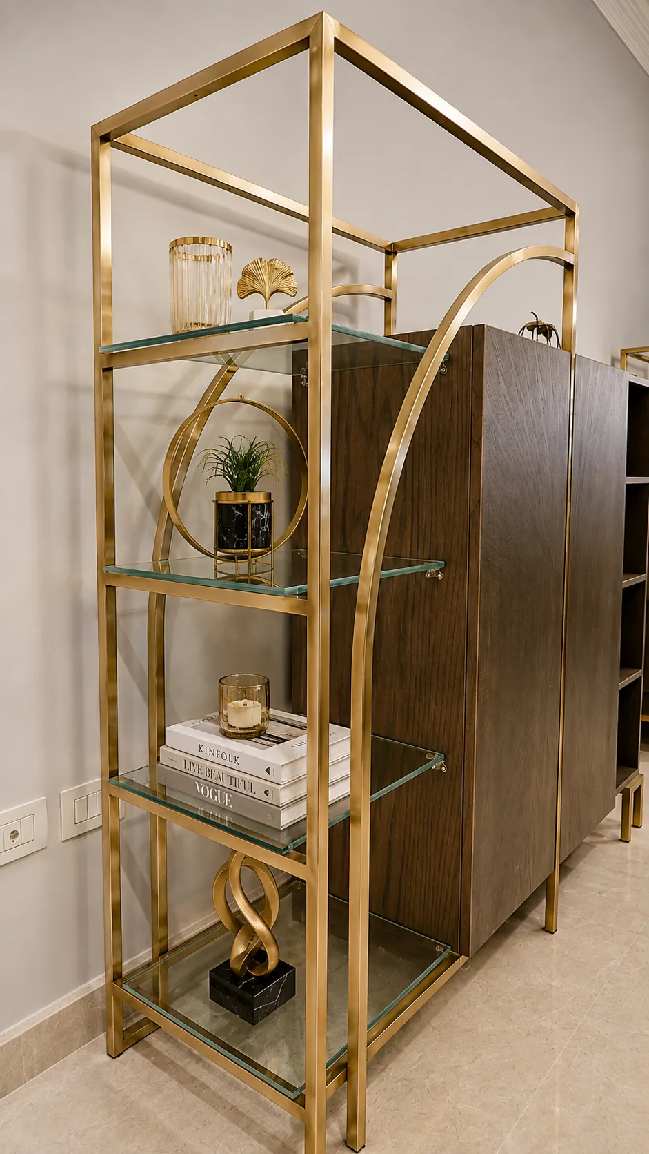 Brass and glass display shelf in the Oraby Villa project in Oraby - Elobour